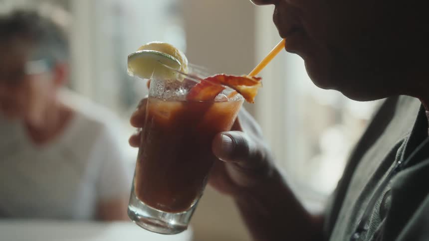A man takes a drink in the restaurant
