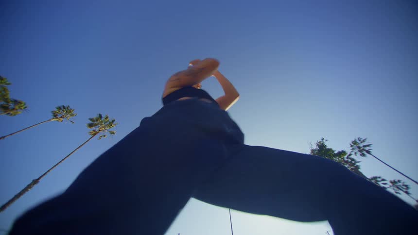 Woman in jeans dancing energetically in an outdoor setting