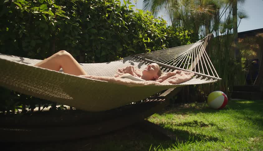 Woman relaxing in a hammock outdoors