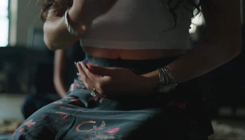 Two women sit on the floor in the room