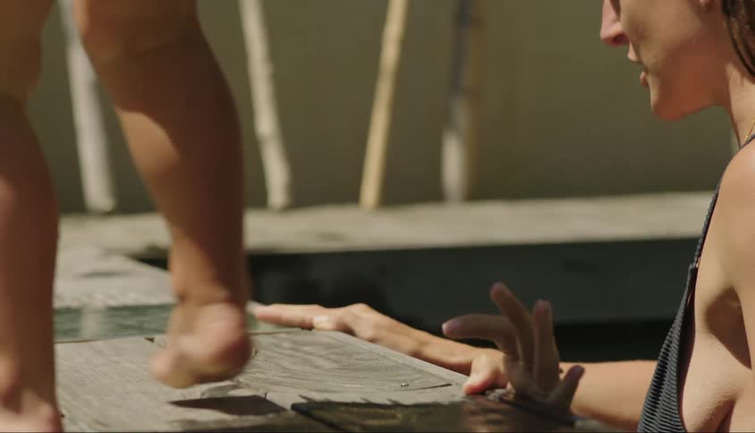 Mother in the pool and a small childs legs at her side