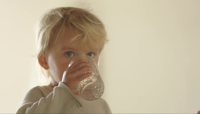 A child drinks a glass of water