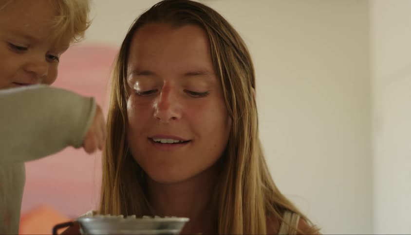 Closeup on mother and son preparing coffee