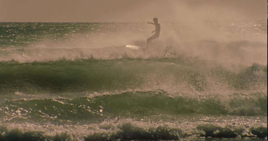 A man is surfing waves