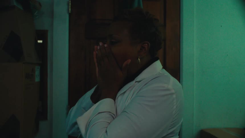 Woman indoors putting on white clothes and going out the door