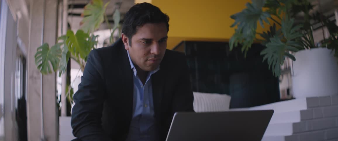 A man is typing on his laptop