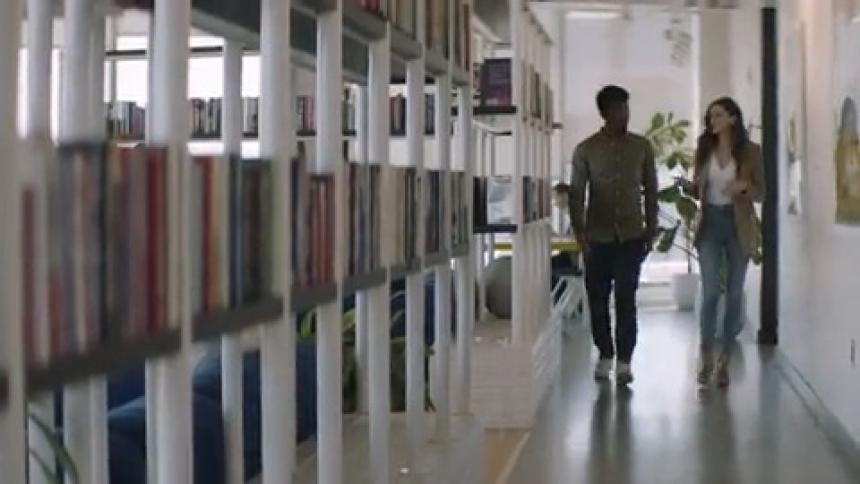 Coworkers walk through the office hall