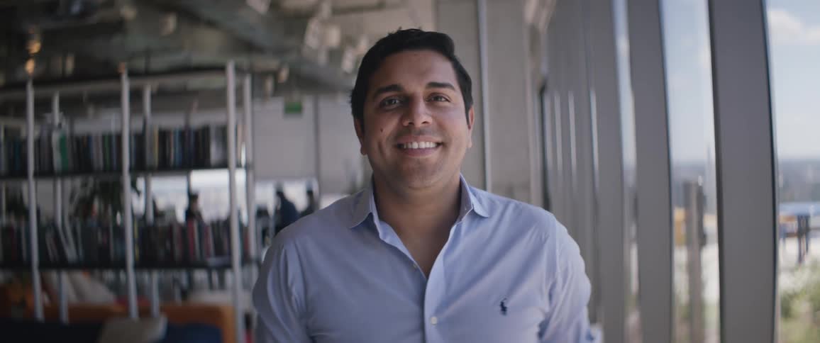 A man smiles in the office