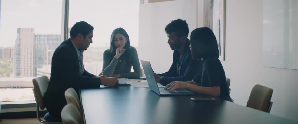 Coworkers talk in the conference room