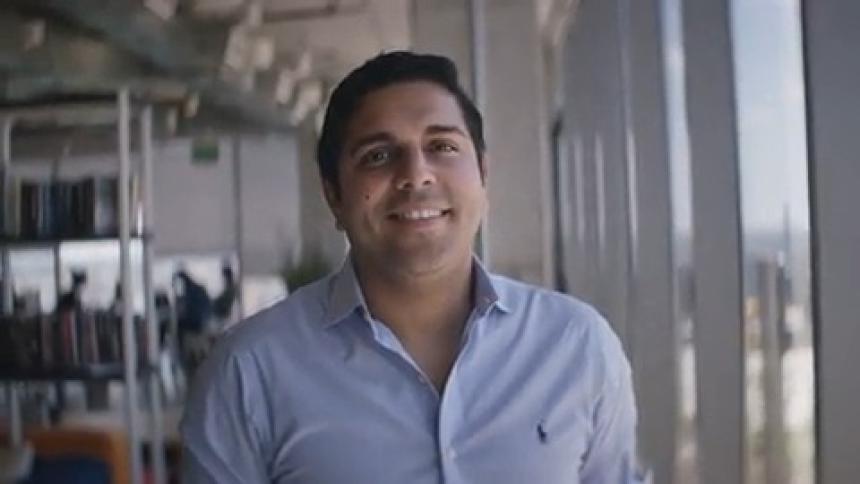A man turns his head and smiles in the office