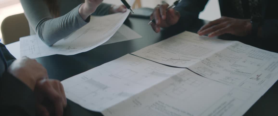 Coworkers meeting in conference room discuss plans