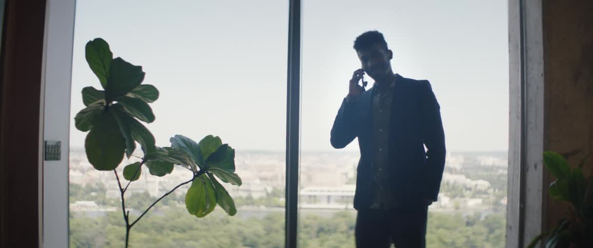 Man talking on cell phone in a work environment