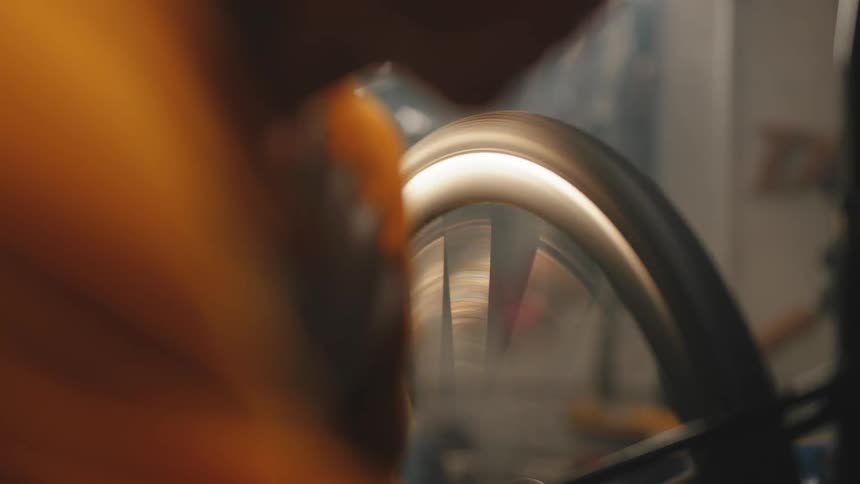 A man works on a bicycle in a shop