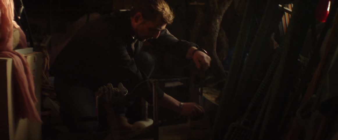 Man sitting on the floor hammering a project