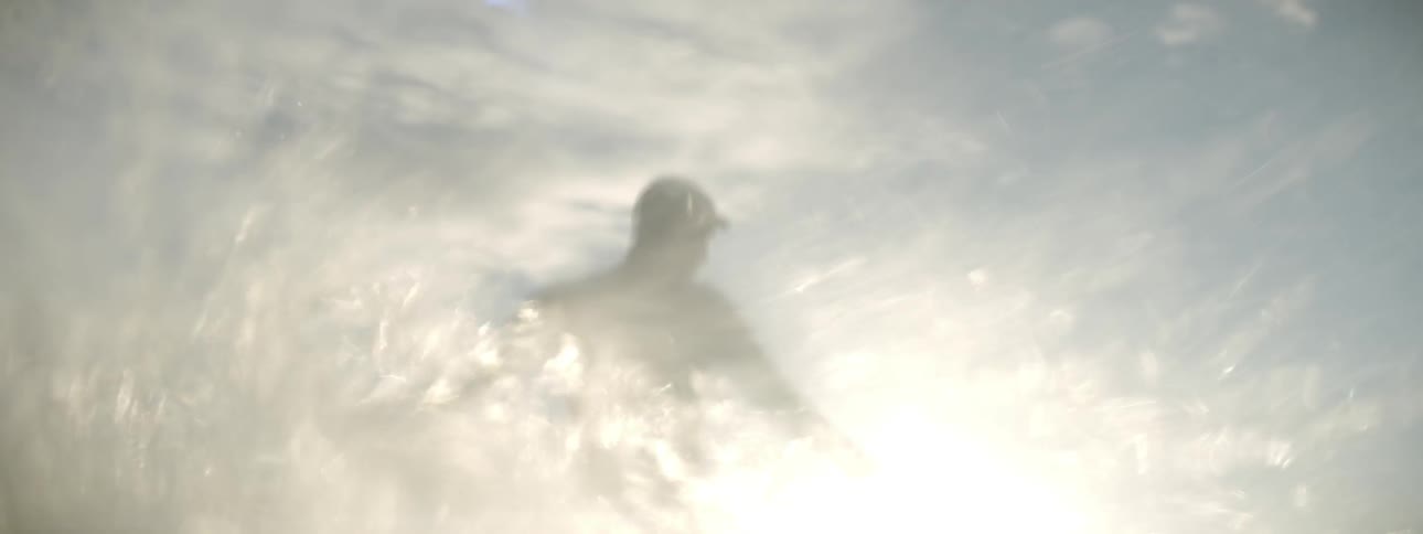 A surfer rides an ocean wave