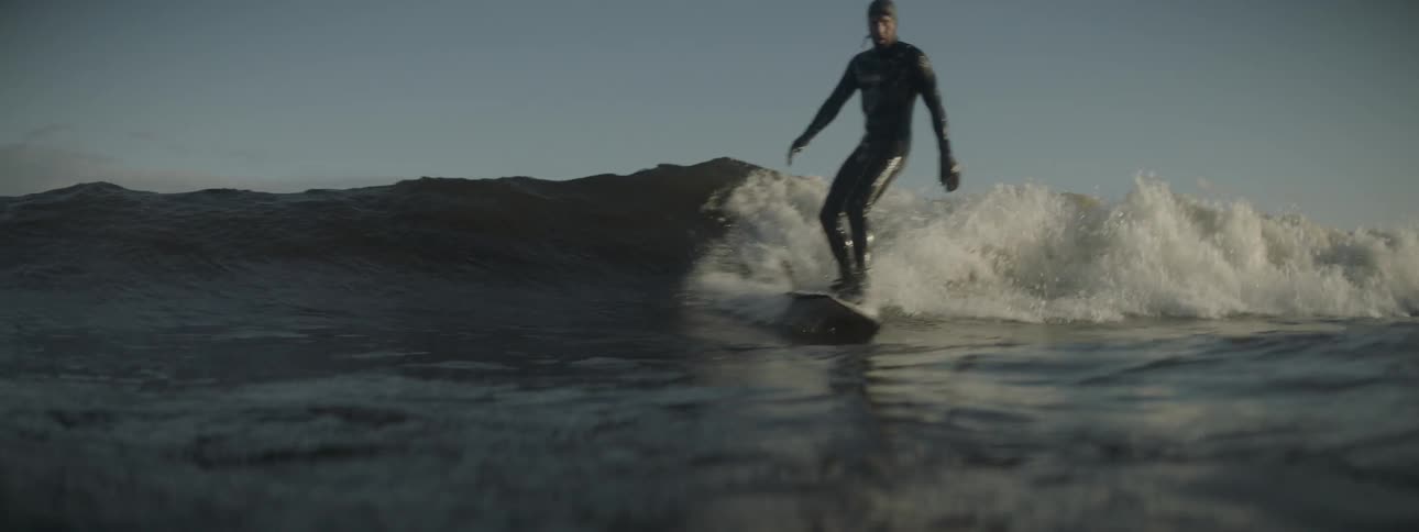 A surfer rides a wave