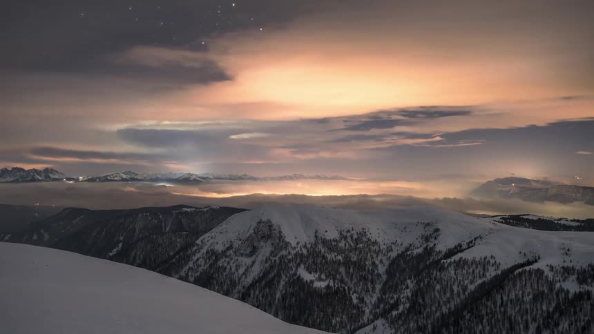 The clouds flow fast over the mountain range