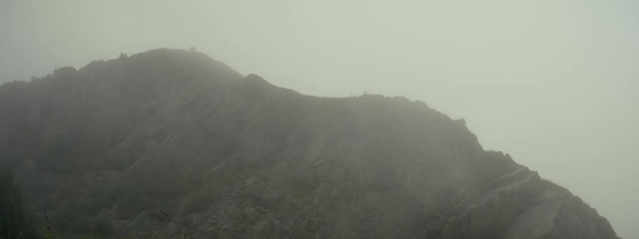 Mountainous landscape shrouded in fog
