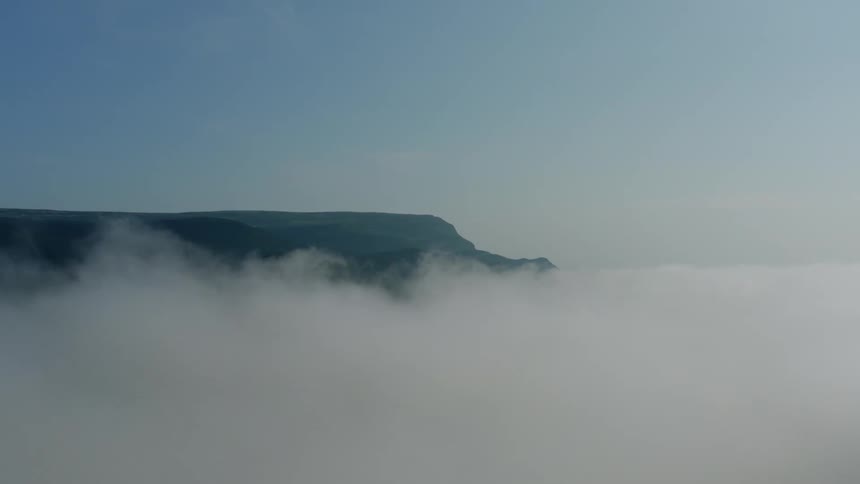 Landscape with dense fog at the bottom and clear sky at the top