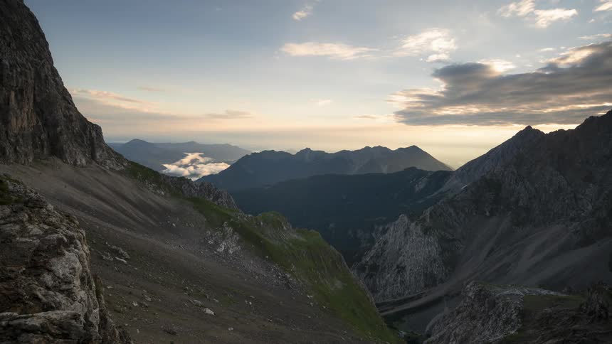 Clouds flow over the mountain range