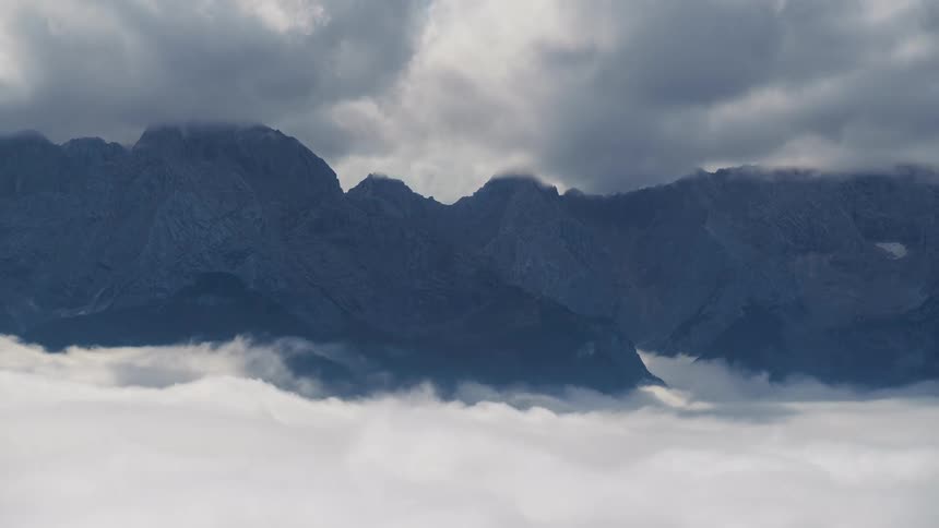 Mountain range with clouds passing by in timelapse