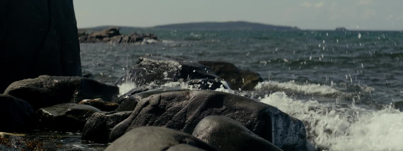 Waves splash against a rocky beach