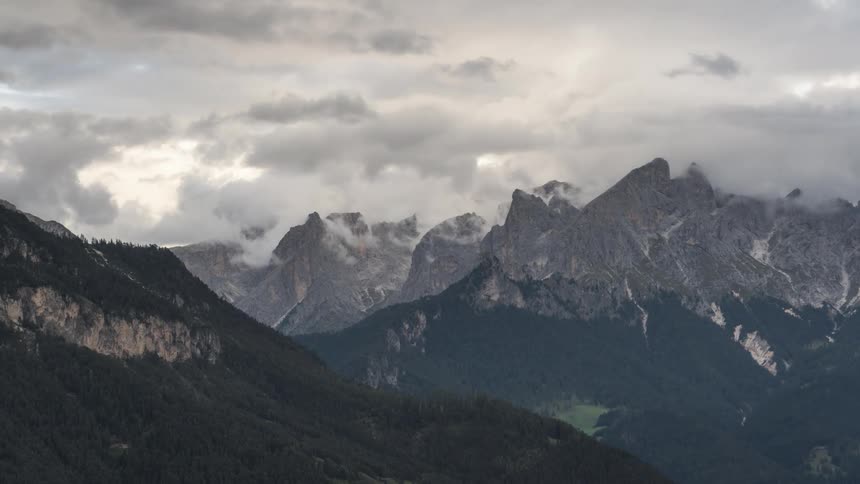 Mountain range with jagged peaks under a cloudy sky