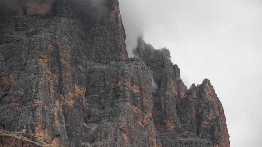 Rocky mountains with cloudy clouds passing by