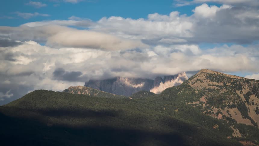 Banks of clouds move over a mountain range