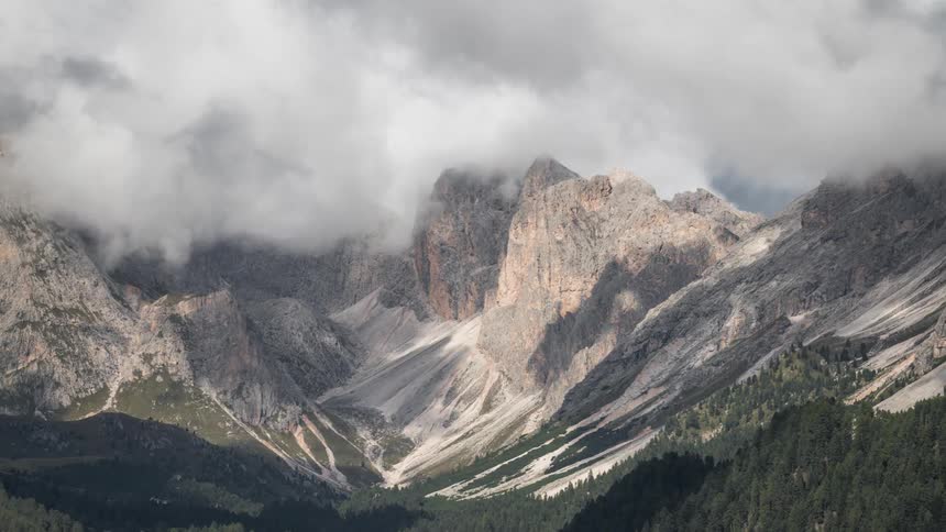Heavy clouds cast a shadow on the mountain range