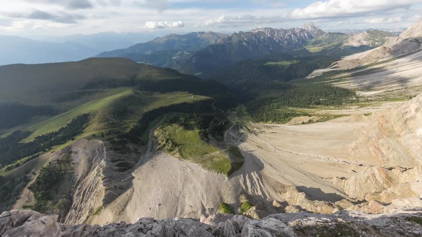 Cloud shadows move across a mountain slope in nature