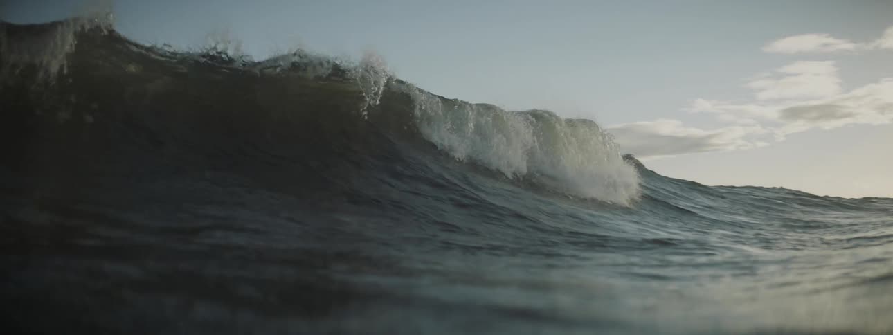 A waves rolling and cresting on a sunny day