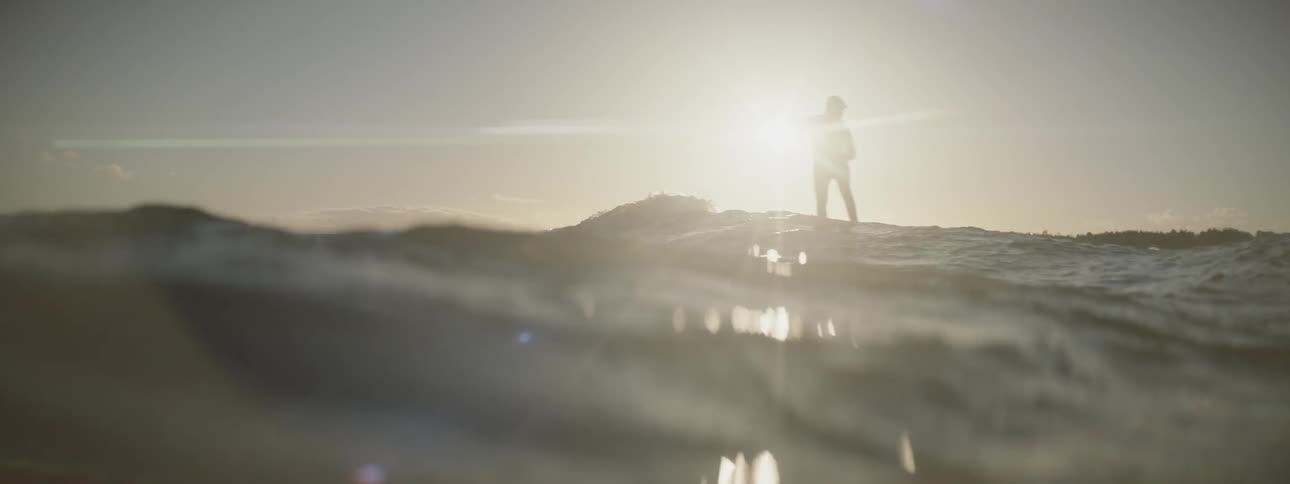 A person riding a surfboard comes to the end of the wave