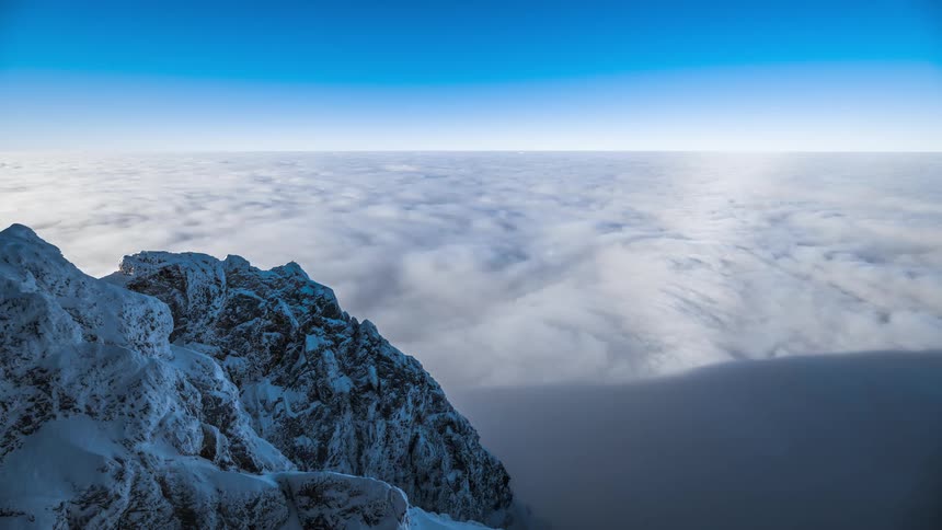 The mountain peak is above the clouds