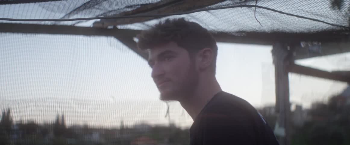 Man is standing behind a net