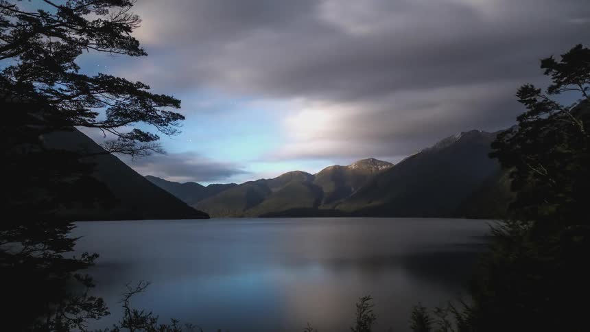 Dark clouds float over a lake in a mountain valley