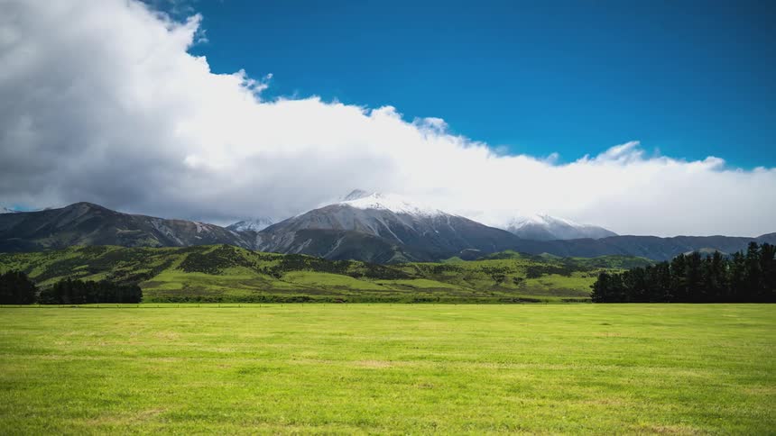 A time lapse of clouds flowing over a mountain range