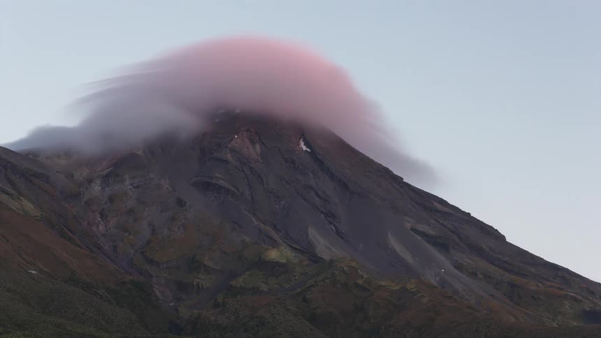 Mountain with a cloud at the top changing the color