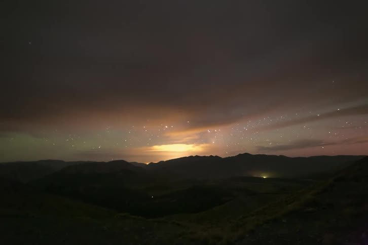 Clouds pass by the starry sky