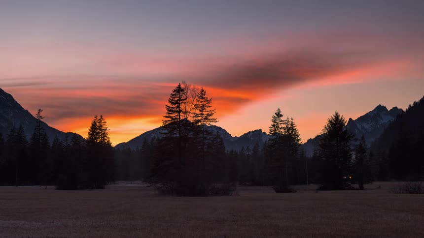 The sun is setting on the mountain range
