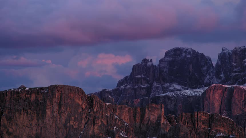 Storm clouds move over a large mountain range