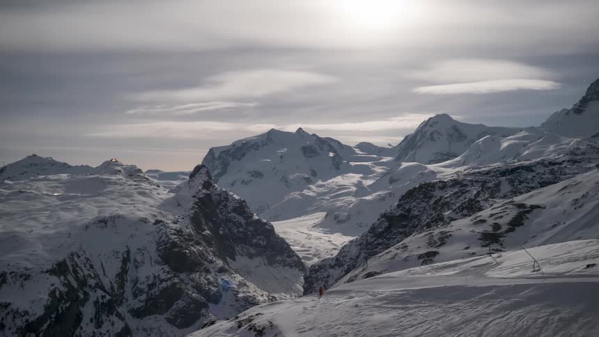 Mountains covered by snow on a cloudy day