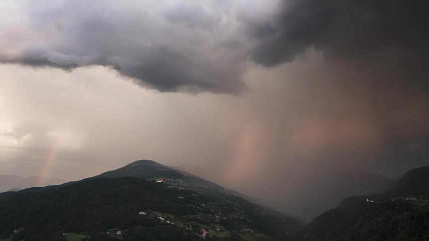 Greenish mountain range in a cloudy sky