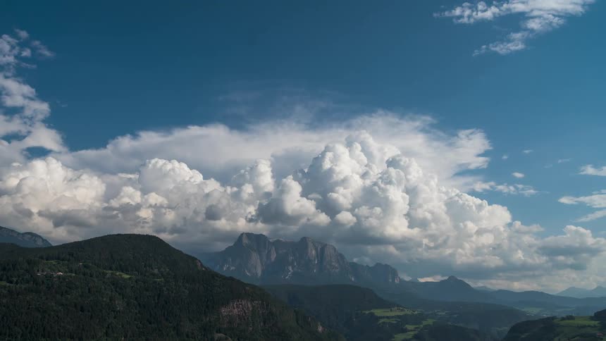 The clouds flow over the mountain valley