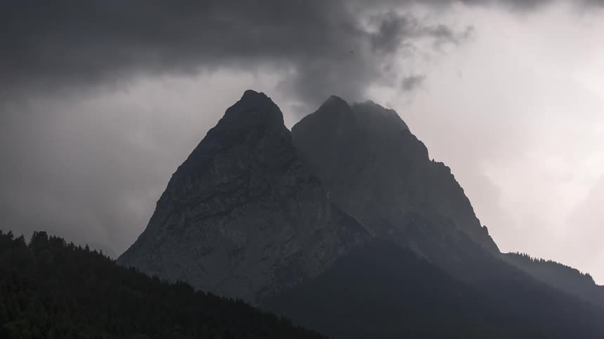 Mountain peaks with modulated clouds passing by