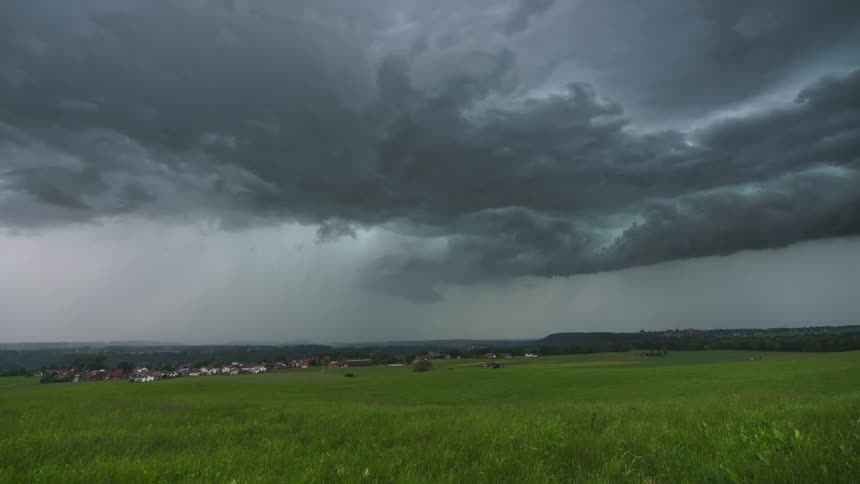 Storm clouds dump rain on a rural town and surrounding area