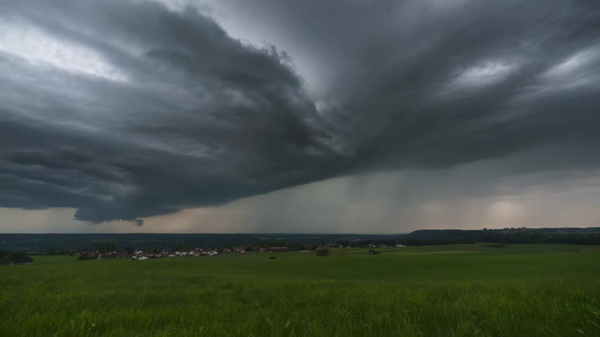 Time lapse of storm clouds rolling over a rural landscape in the plains