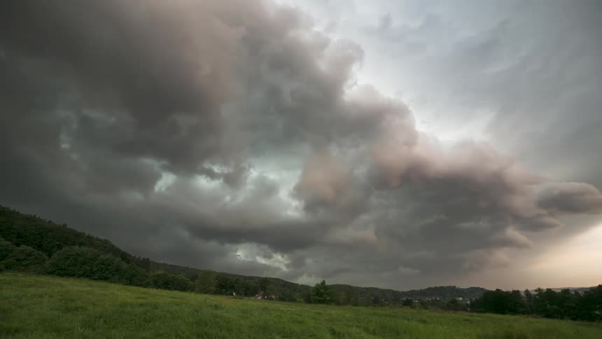 Storm clouds with rain move over a rural area