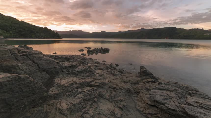 A lake between mountain areas ripples