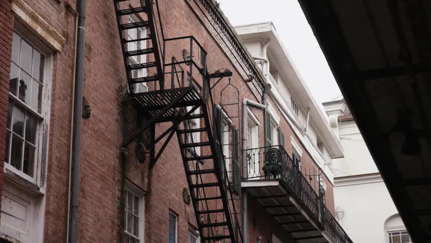 Looking at the side of a building with a wrought iron fire escape
